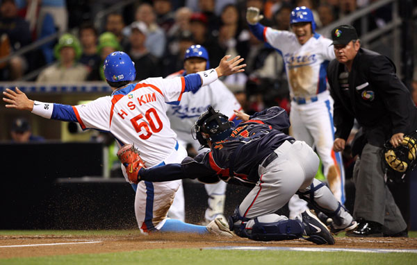 18일 미국 샌디에이고 펫코파크에서 열린 2009 월드베이스볼클래식 2라운드 한국과 일본의 경기 1회말 1사 만루 상황에 이진영의 좌전안타때 2루 주자 김현수가 홈을 밟아 3-0으로 만들고 있다./연합뉴스