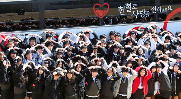  20일 안양 성문고등학교에서 대한적십자사 경기지사 혈액원의 단체헌혈을 마친 학생들이 “헌혈로 사랑을 전하세요”라고 외치며 손으로 하트모양을 그리고 있다. 이날 성문고등학교에서는 오전부터 오후까지 약 300여명의 학생들이 헌혈행사에 참여했다.