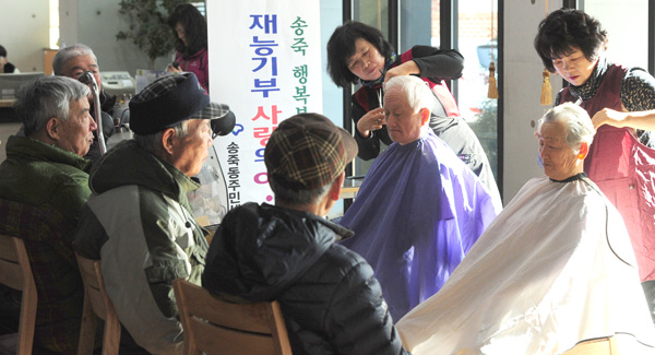  송죽동 미용사들로 구성된 미용봉사단이 2일 수원 송죽동 주민센터에서 장애인, 노인 등 주민들의 머리를 손질해주는 미용봉사 활동을 벌이고 있다./노경신기자 mono316@
