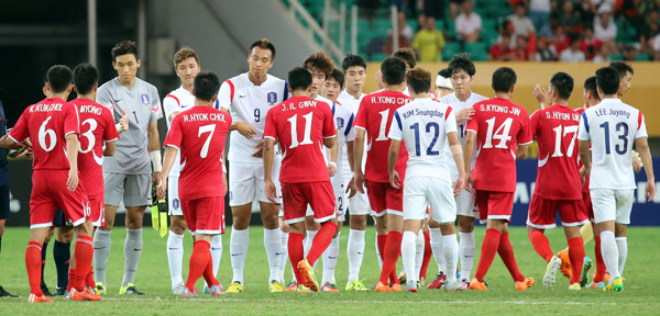 9일 중국 후베이성 우한 스포츠센터에서 열린 2015 동아시아축구연맹(EAFF) 축구선수권대회 남자부 한국과 북한의 3차전 경기에서 득점없이 무승부를 기록한 한국(흰색 유니폼)과 북한 선수들이 경기가 끝난 뒤 악수를 나누고 있다./연합뉴스