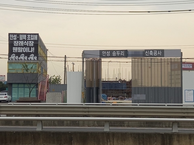 안성시 공도읍 승두리 안성IC 인근에 장례식장 신축공사가 진행 중인 가운데 바로 옆에 위치한 모 대학교 건물 외벽에 공사 중지를 요구하는 플랜카드가 내걸렸다. (사진=노성우 기자)