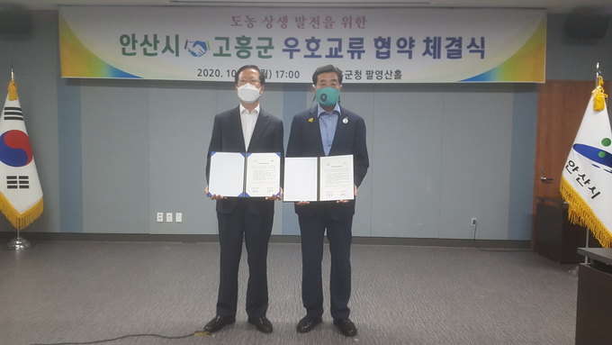 19일 오후 전남 고흥군청에서 열린 도농 상생 발전을 위한 안산시-고흥군 우호교류협약 체결식에서 윤화섭 시장(오른쪽)과 송귀근 고흥군수가 협약서에 서명한 뒤 기념사진을 찍고 있다. (사진=김준호 기자)