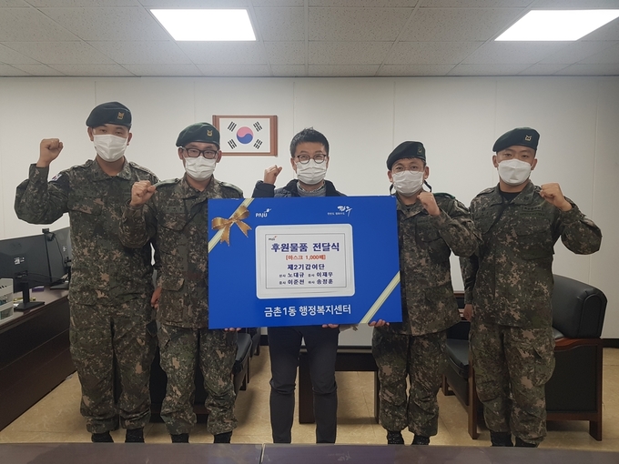 육군 2기갑여단 부사관들이 금촌1동에 마스크를 전달하고 있다. (사진=파주시 제공)