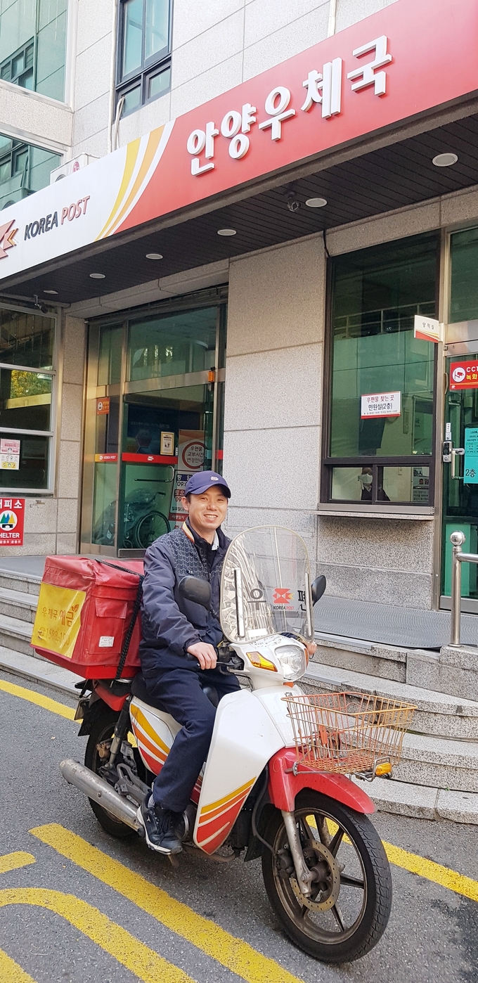 주성권 주무관이 안양우체국 앞에서 기념촬영을 하고 있다. 주성권 주무관은 지난 3일 배달 중 주택에서 연기가 나는 것을 발견하고 신속한 조치를 취해 화재예방에 기여했다. (사진=경인지방우정청) 