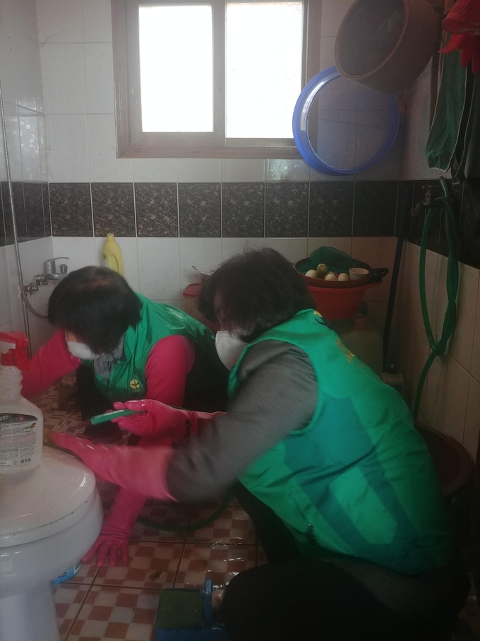 지난 17일 화성시에 위치한 한 치매어르신의 집을 방문해 봉사활동을 펼치고 있는 직장·공장새마을운동경기도협의회 회원들. (사진=직장·공장새마을운동경기도협의회 제공)
