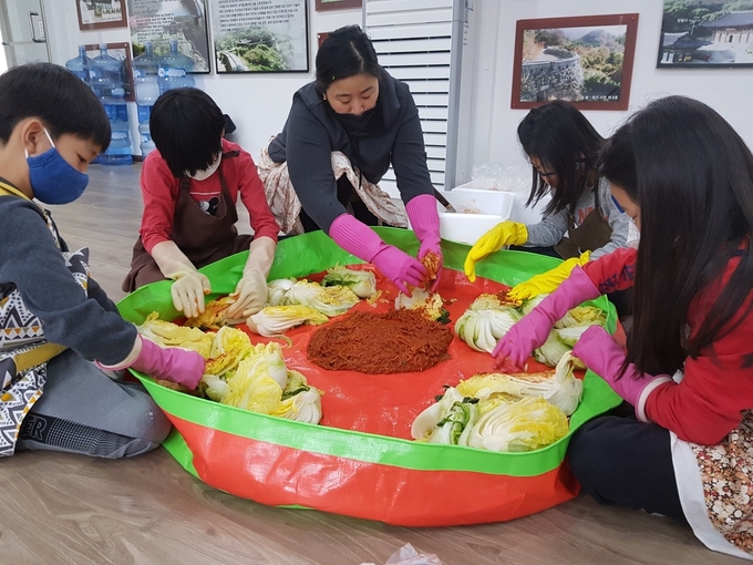 광주시 관내 남한산초등학교 교장과 교사 학생들이 어려웃 이웃들을 위해 김장김치를 담그고 있다. (사진=남한산초교 제공)