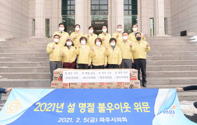 파주시의회 의원들이 이웃돕기 물품 앞에서 작은 도움이 되길 바라며 사진을 찍고 있다. (사진=파주시의회 제공)