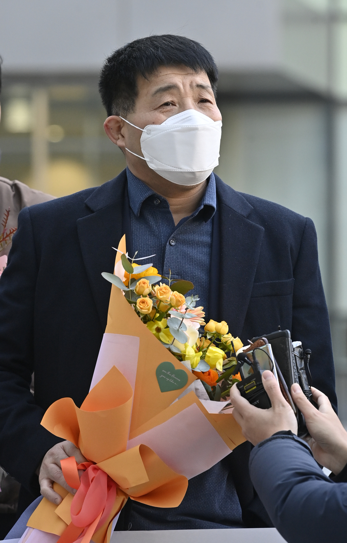 꽃다발을 들고 법정 앞에서 소감을 밝히고 있는 윤성여 씨. (사진=황준선 기자)