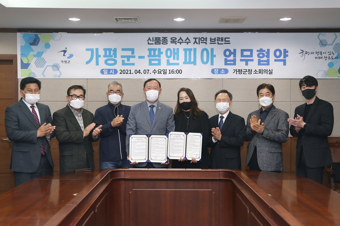 7일 가평군청 소회의실에서 가평군과 농산물 유통기업 팜앤피아가 ‘가평 옥수수 글로벌 브랜드화’를 위한 업무협약을 체결한 가운데 김성기 가평군수 등 참석자들이 협약서를 들고 기념촬영을 하고 있다. (사진=가평군 제공)