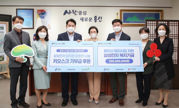 백군기 용인시장이 22일 용인시에 2억 원을 기탁하고 키오스크 기부금 후원을 약속한 삼성전자 DS부문 관계자들과 기념촬영을 하고 있다.. (사진=용인시 제공)