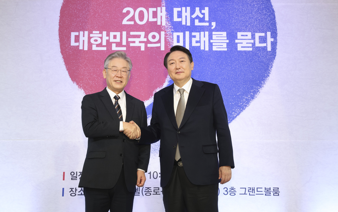 더불어민주당 이재명 대선 후보(왼쪽)와 국민의힘 윤석열 대선 후보가 24일 오전 서울 종로구 포시즌스 호텔에서 중앙일보 주최로 열린 '2021 중앙포럼'에 참석해 악수하고 있다. (사진=국회사진기자단/연합뉴스)