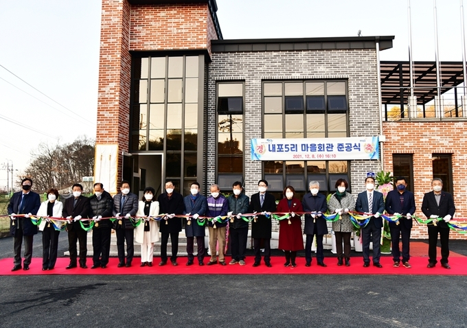 파주시 문산읍 내포5리 마을회관 준공식에 참가한 내빈들이 축하 테잎을 자르고 있다. (사진=파주시 제공)