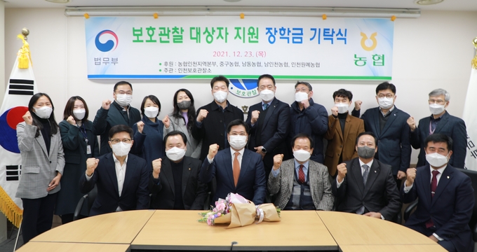 인천농협 이강영 본부장이 인천보호관찰소를 방문, 청소년 장학금을 전달하며 관계자들과 파이팅을 하고 있다. ( 사진 = 인천농협 제공 )