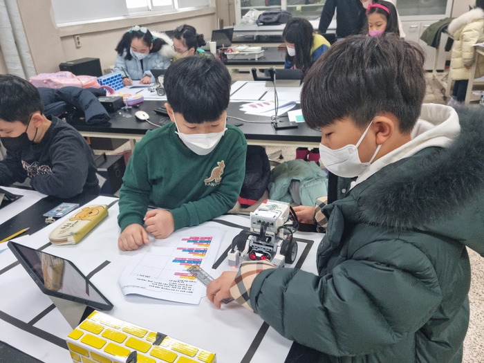 과학영재교육원 브릿지과정 학생들이 ‘로봇코딩과 로봇배틀’ 수업에서 로봇작동을 위한 코딩을 하고 있다. (사진=가천대학교 제공)