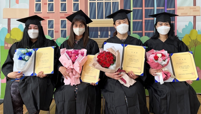중구다문화가족지원센터 초교졸업 검정고시 교육을 이수한 결혼이민여성들이 수료장을 들어보이고 있다. ( 사진 = 중구 제공 )