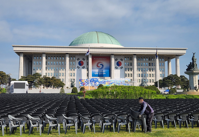= 제20대 대통령 취임식을 나흘 앞둔 6일 국회 잔디광장에서 관계자들이 취임식 참석자들의 의자를 설치하고 있다. (사진=국회사진기자단/연합뉴스)