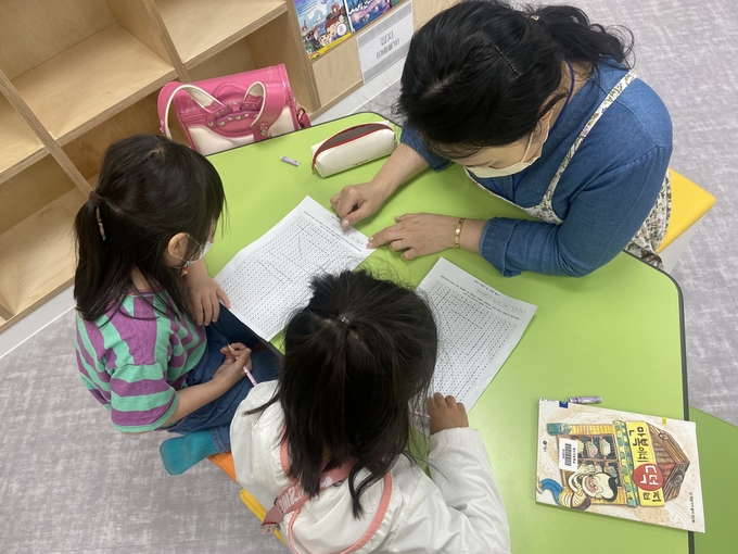 청수초 꿈마루도서관 에서 독서행사에 참여하고 있는 학생이 엄마하고 속담 퍼즐을 즐기고 있다. (사진=청수초 제공)