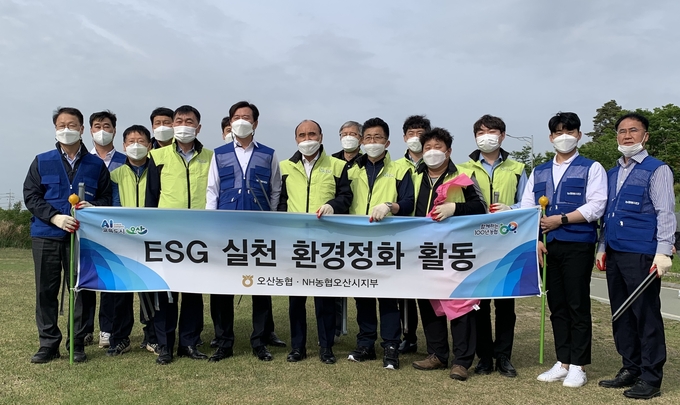 NH농협 오산시지부와 오산농협이 지난 11일 “ESG 경영 실천” 오산천 환경정화활동을 실시후 기념촬영을 하고 있다.(사진=NH농협 오산시지부 제공)