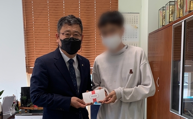 표동진 경안동장이 가정의 날을 맞아 관내 저소득층 가정 학생에게 문화 상품권을 전달하고 있다.(사진=광주시 제공)