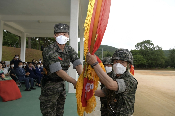 해병대 제2사단 연병장에서 치러진 사단장 취임식에서 전임 사단장으로부터 조영수(오른쪽) 신임 사단장이 군기를 이양받고 있다. (사진=해병2사단 제공)