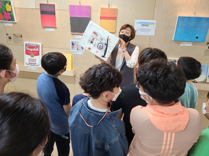  이진희 사서교사가 학생들에게 미술작품을 설명하고 있다. (사진=천일초등학교 제공)