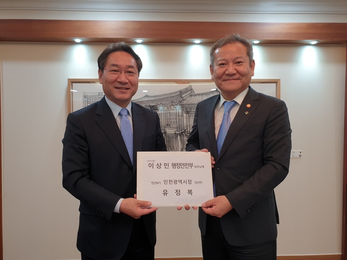 지난 27일 행정안전부를 찾은 유정복 인천시장 당선인(왼쪽)이 이상민 장관에게 건의사항을 전달하고 있다. ( 사진 = 유정복 인수위 제공 )
