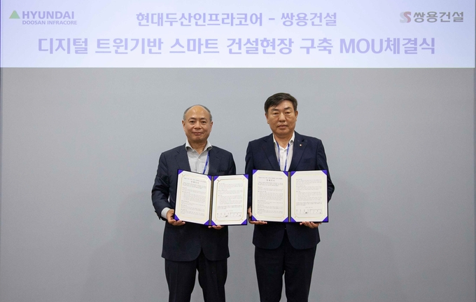 현대두산인프라코어와 쌍용건설 관계자들이 '스마트 건설현장 구축 MOU'를 체결한 뒤 기념촬영을 하고 있다. ( 사진 = 현대두산인프라코어 제공 )
