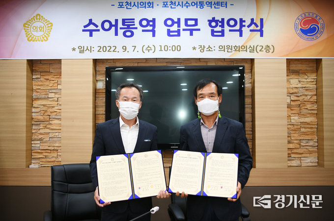 포천시의회 서과석 의장(왼쪽)과 포천시수어통역센터 유인기 센터장(오른쪽)이 협약서를 들어보이고 있다. (사진=포천시의회 제공)