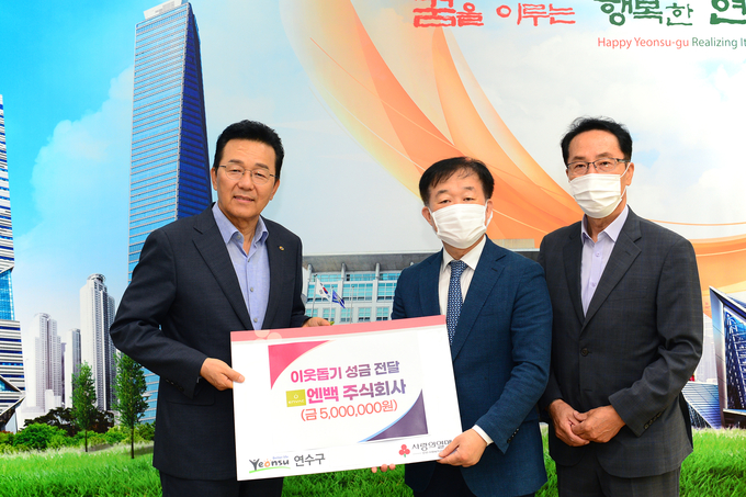 엔백 주식회사 정영훈 대표(가운데)가 연수구에 이웃돕기 성금 500만원 전달한 뒤 이재호 구청장(왼쪽)과 기념촬영을 하고 있다. ( 사진 = 연수구 제공 )
