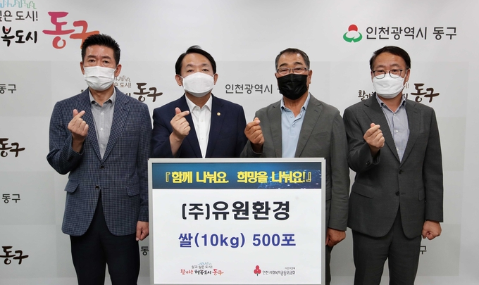 인천 동구청에서 유원환경 대표와 김찬진 구청장이 쌀 전달식에서 함께 사진촬영을 하고 있다. ( 사진 = 동구 제공 )