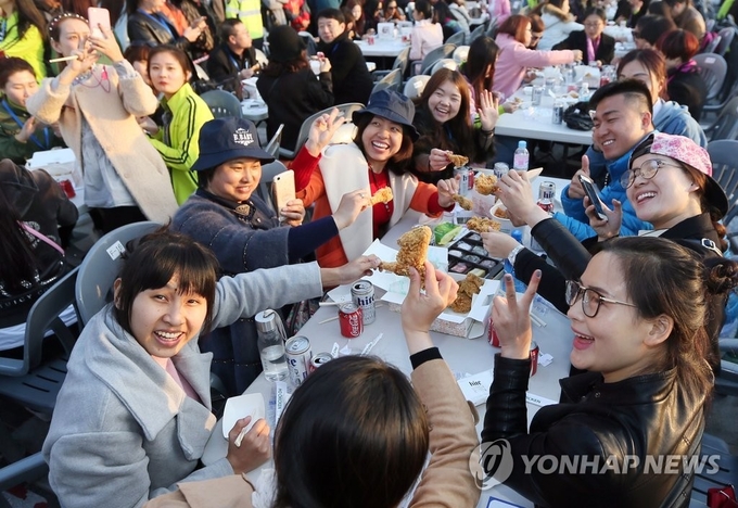 지난 2016년 인천 중구 월미도에서 아오란 그룹 임직원들이 치킨과 맥주를 먹고 있다. ( 사진 = 연합뉴스 제공 )