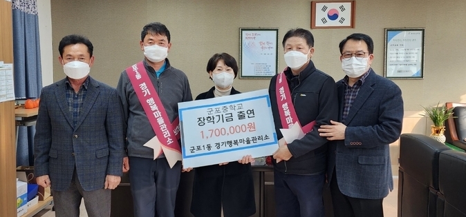 군포1동 경기행복마을관리소 지킴이 12명은 월급의 일정액을 모아 170만원의 장학금을 지난 24일 군포중학교에 전달했다.(사진=군포중 제공)
