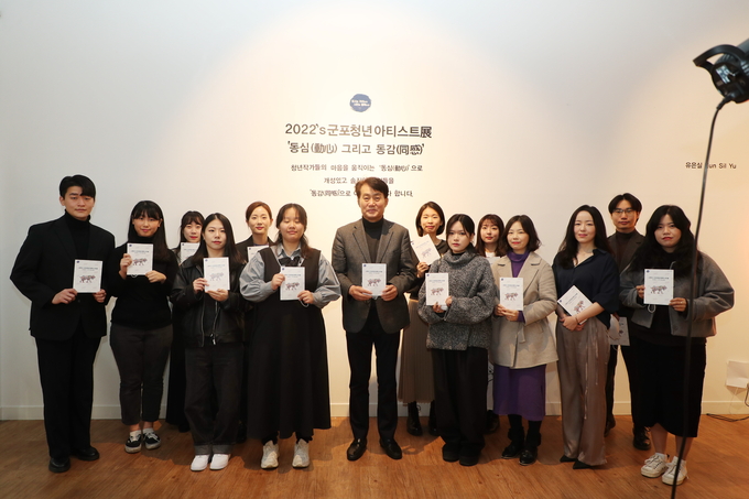하은호 군포시장이 지난 9일 열린 ‘2022 군포청년 아티스트展:동심(動心) 그리고 동감(同感)’ 전시장을 찾아 김포 청년작가들과 함께 기념촬영을 하고 있다.(사진-군포시 제공)<br>
