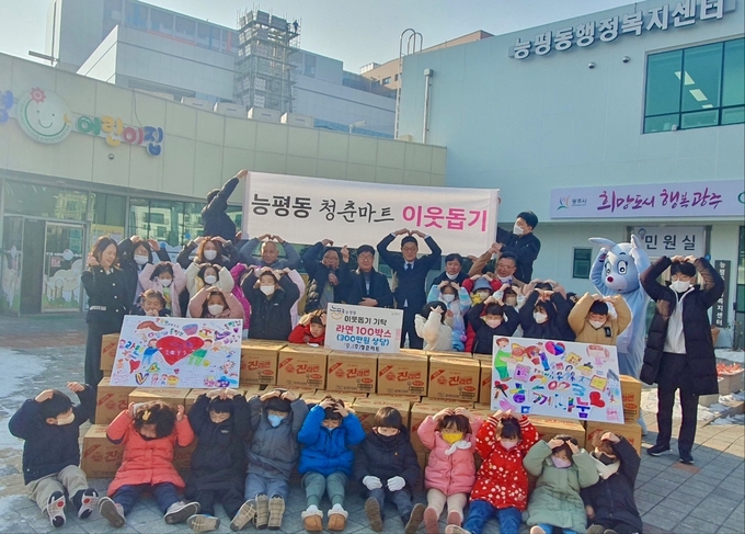 김주현 청춘마트대표와 주민들이 어려운 이웃을 위해 전해달라며 권성동 능평동장에게 라면을 전달하고 있다 광주시 제공
