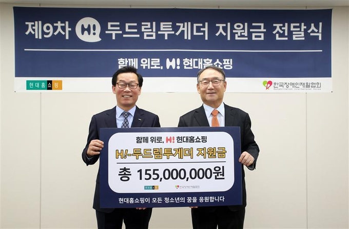 17일 오전 서울 강동구에 위치한 현대홈쇼핑 본사에서 임대규 현대홈쇼핑 사장(사진 왼쪽)이 김인규 한국장애인재활협회장에게 ‘H! 두드림투게더’ 지원금 1억 5500만ㅜ원을 전달하고 기념사진을 촬영하고 있는 모습. (사진=현대홈쇼핑 제공)