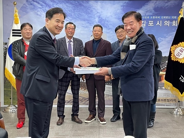 김포평화누리케이블카 설치 추진위원회 (전 강경구 시장 )위원장이 김포시의회를 방문해 김인수 (왼쪽)의장에게 시민제안건의문을 전달하고 있다..(사진=추진위 제공)