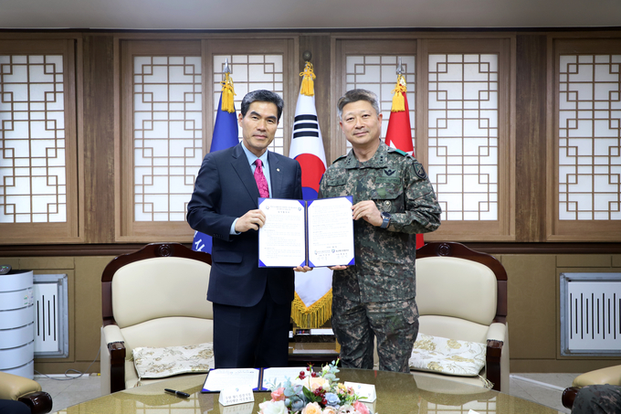 6일 육군 제 51보병사단에서 열린 (재)경기도수원월드컵경기장관리재단과 육군 제51보병사단의 업무협약식에서 이민주 재단 사무총장(왼쪽)과 류승민 사단장이 기념사진을 찍고 있다. (사진=경기도수원월드컵경기장관리재단 제공)