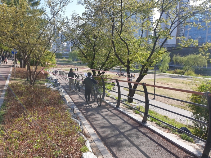 9일 오후 시민들이 출입 전면 통제 안내에도 불구하고 정자교 인근 탄천 진입로를 통과하고 있다. (사진=나규항 기자)