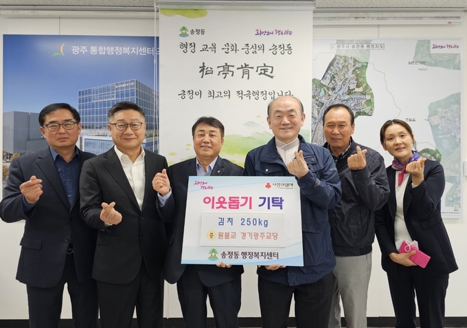 능산 김현국 원불교 경기광주교당 교무등 회원들이 어려운이웃을 위해 최정식 송정동장에게 사랑의 김치를 전달하고 있다. (사진=광주시 제공)