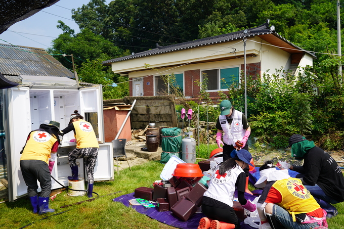 지난 21일 충북 괴산군 불정면 하문리 일원에서 적십자사봉사회 경기도협의회 봉사원들이 수해 복구 지원을 하고 있다. (사진=대한적십자사 경기도지사 제공) 