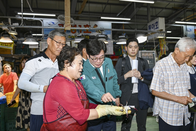 11일 대명항 어촌계 회의실에서 열린 ‘현장 소통을 마친 김병수 김포시장(가운데)이 수산물을 구입하고 있다. 김포시청제공