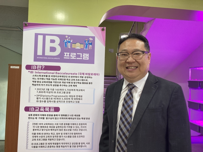 지난 2일 김태훈 서해중 교장이 IB교육 안내문 앞에서 포즈를 취하고 있다. (사진=이보현 기자)