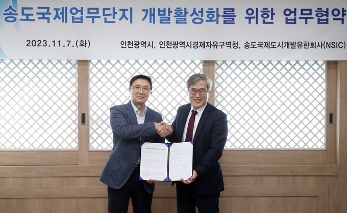 김진용 인천경제청장(오른쪽)과 신문식 NSIC 대표이사가 송도국제업무단지 개발활성화 업무협약을 맺고 기념촬영을 하고 있다. ( 사진 = 인천경제청 제공 )