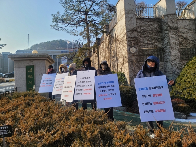 감정4지구 도시개발 10여 개 하청업체 대표들이 시청 정문 앞에서 피켓 시위를 벌이고 있다. (사진=천용남 기자)
