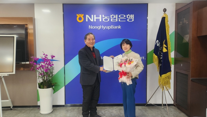 김민자 NH농협은행 경기영업본부장(오른쪽)이 24일 수원특례시 인계동 위치한 NH농협은행 경기지점에서 박동우 경기도레슬링협회 선거관리위원장으로부터 임명장을 건내 받고 기념시진을 찍고 있다. (사진=경기도레슬링협회 제공)