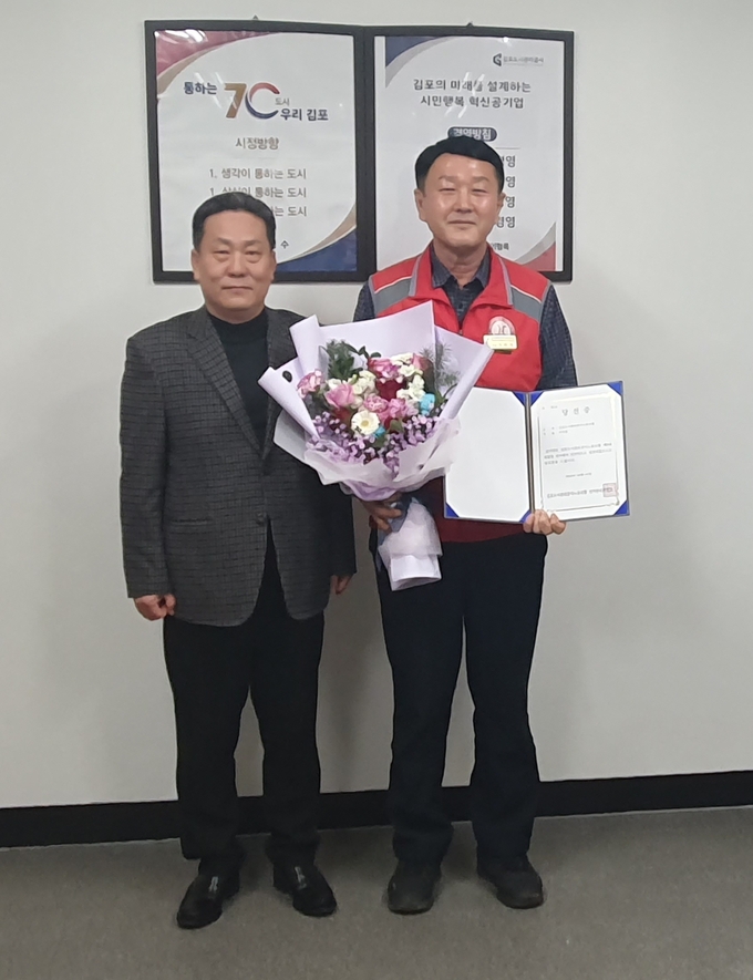 제9대 김포도시관리공사노동조합 위원장으로 당선된 이덕재 위원장이 당선증과 꽃달발을 들고 기념사진을 찍고 있다. 김포도시관리공사제공