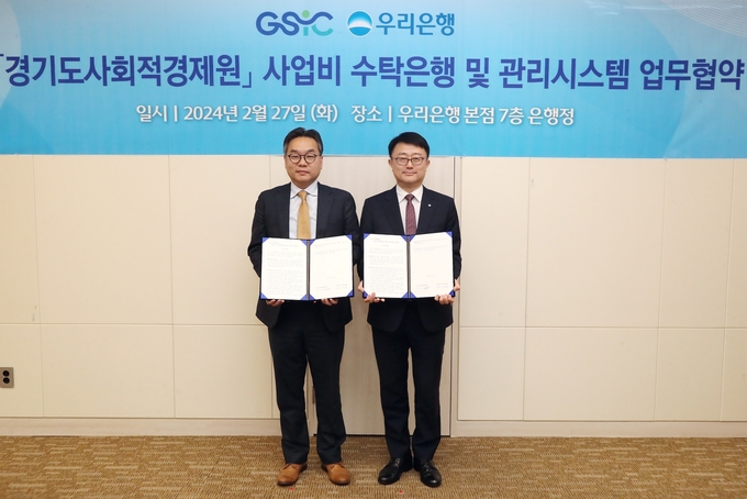 조세형 우리은행 기관그룹장(오른쪽)이 지난 27일 업무협약식에서 유훈 경기도사회적경제원장과 기념촬영을 하고 있다. (사진=우리은행 제공)