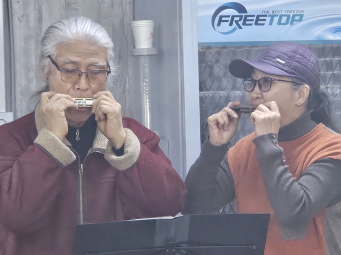 92년 시집 ‘풀꽃’을 냈던 김종태(왼쪽) 시인과 라시 하모니카 교실의 이재순 선생님이 특별 출연해 하모니카를 연주하고 있다.(사진=신소형 기자)
