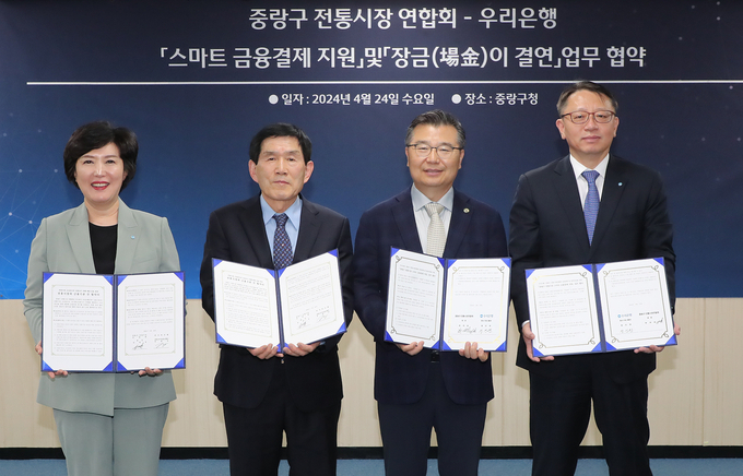(왼쪽부터) 정현옥 우리은행 금융소비자보호그룹 부행장, 한대섭 중랑구 전통시장 연합회장, 류경기 중랑구청장, 정진완 우리은행 중소기업그룹 부행장 등 참석자들이 협약식에서 기념촬영을 하고 있다. (사진=우리은행 제공)
