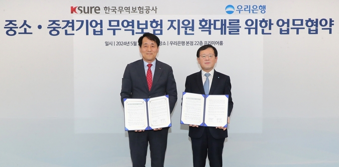 조병규 우리은행장(오른쪽)이 장영진 한국무역보험공사 사장과 협약식에서 기념촬영을 하고 있다. (사진=우리은행 제공)